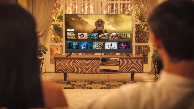 Couple watching TV on couch