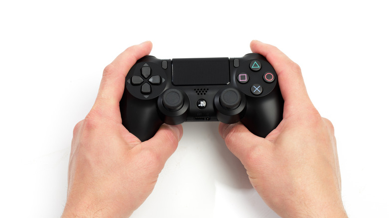 person holding ps4 controller