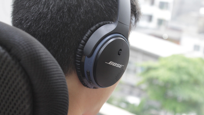 man using Bose headphones outdoors