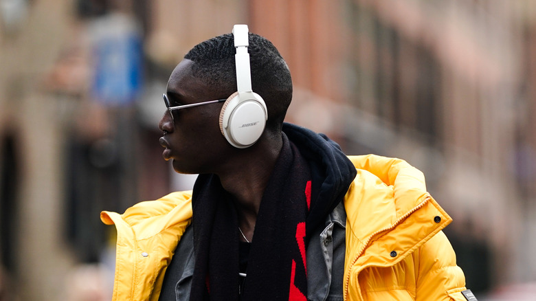 model wearing Bose headphones