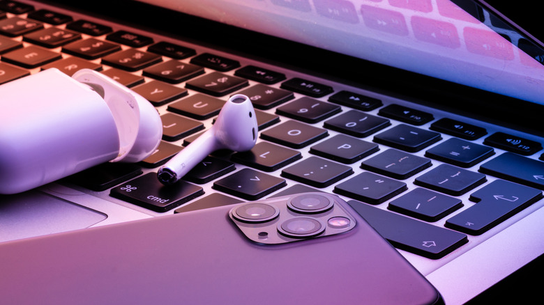 AirPods and iPhone on MacBook's keyboard