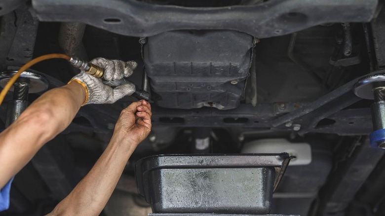 person installing transmission pan