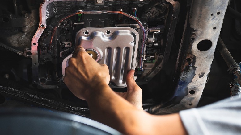 person removing automatic transmission filter