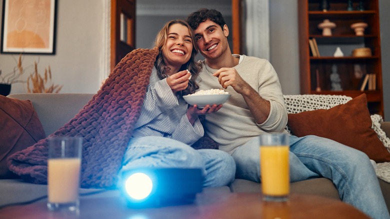 Couple using projector 