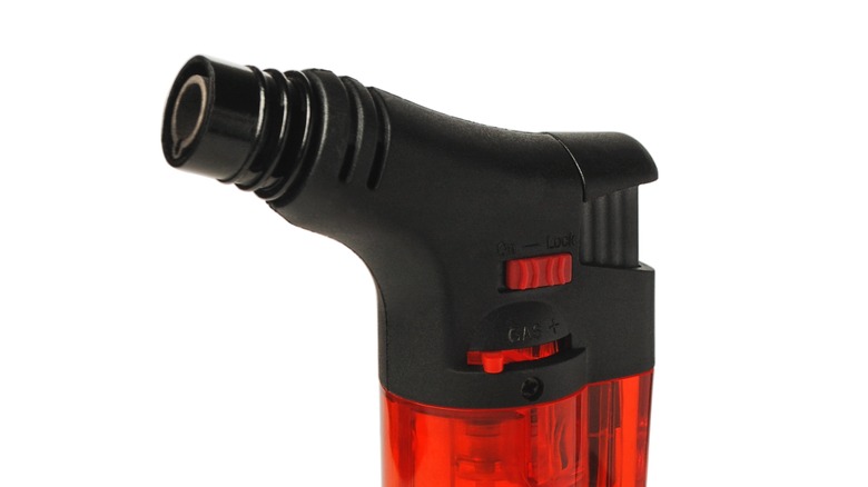 Flame adjuster switch on butane torch