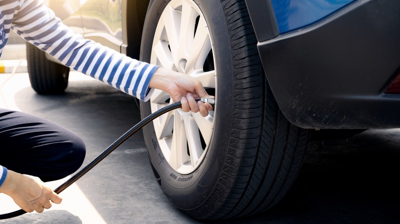 person putting air in tire