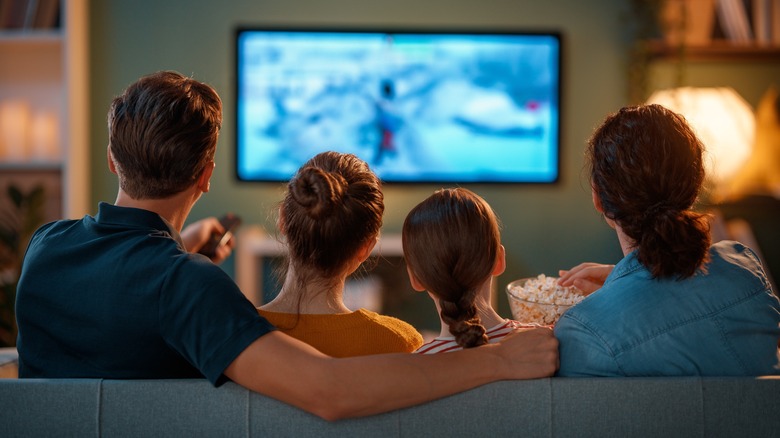 Family of four watching TV