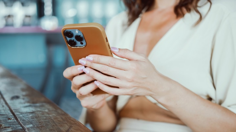 woman holding iPhone