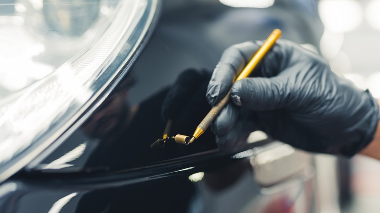 applying touch up paint to a car