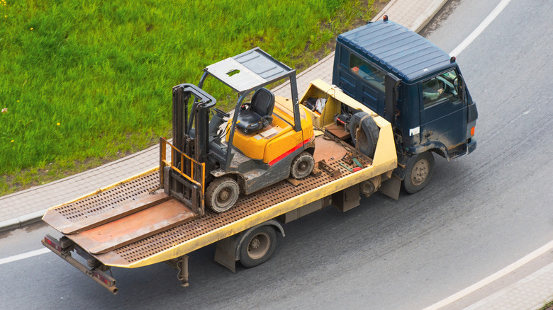 forklift on transport truck bed