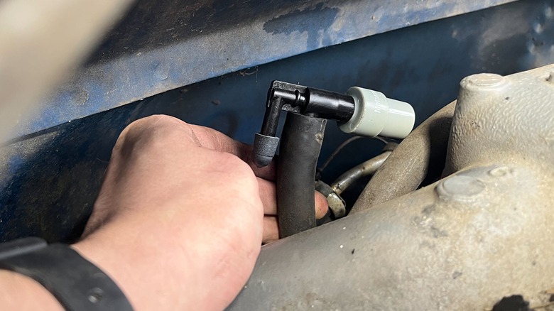 Person reinstalling PCV valve