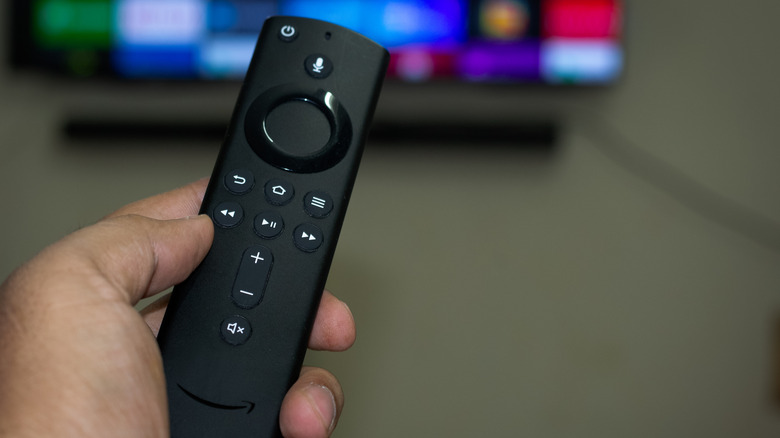 Fire TV Stick remote in hand