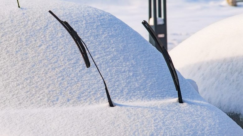 windshield wipers raised up on a snow-covered car