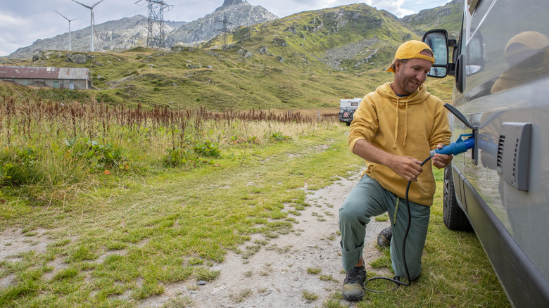 Man holding RV power cable 