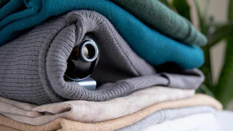 Camera hidden in folded clothing