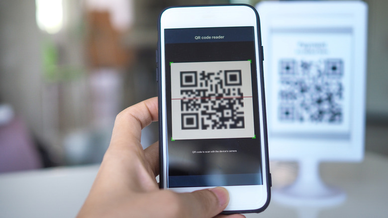 person scanning a QR code