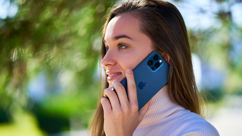 Woman talking on iPhone 12