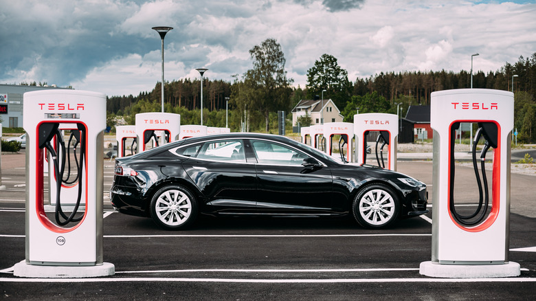 Tesla parked with chargers