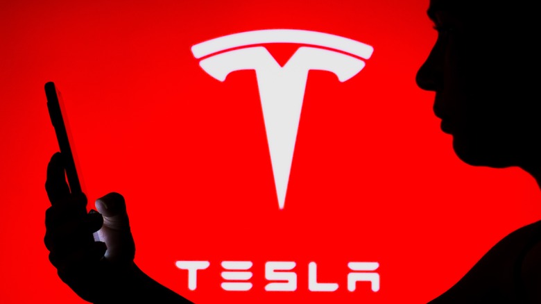 phone with tesla logo behind