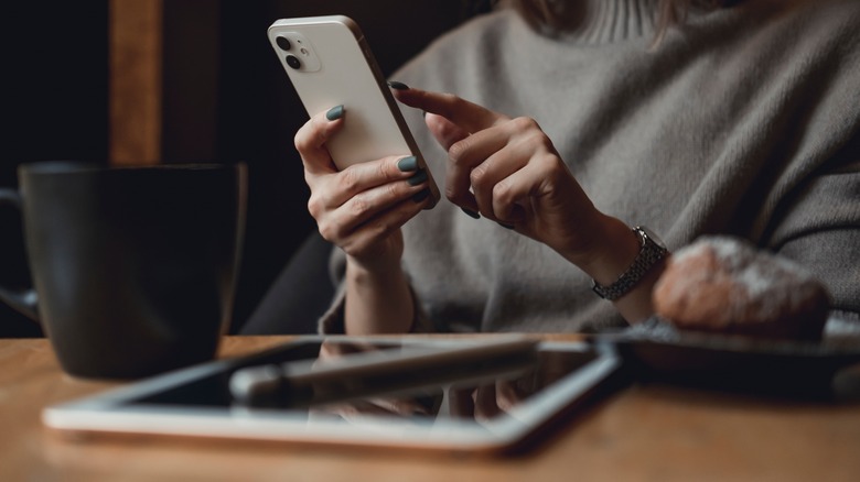 woman with iphone and ipad