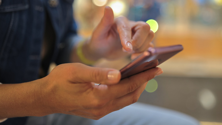 woman using an android mobile phone