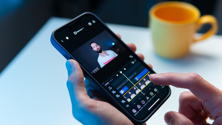 man editing video on phone