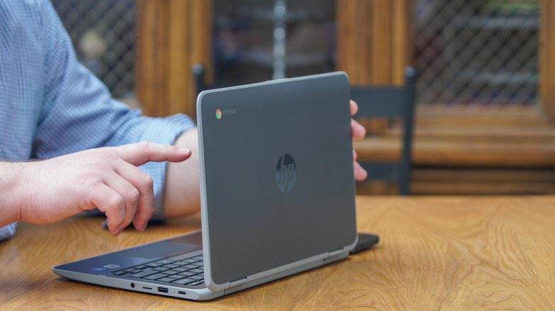 Man using Chromebook laptop touch screen