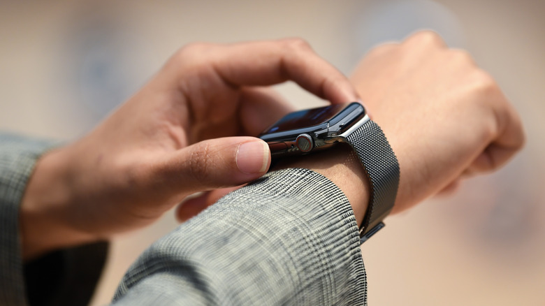 person using apple watch on wrist