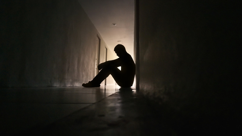 A person sitting on the floor indoors 