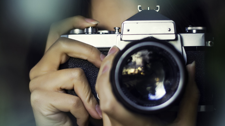 A photographer holding a camera