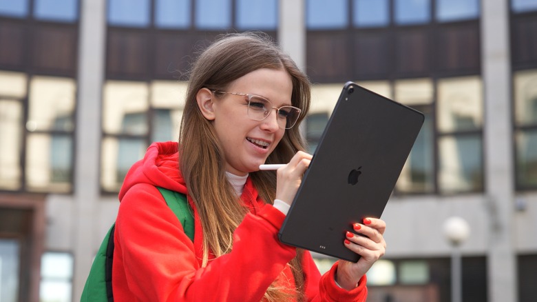 woman using iPad outdoors