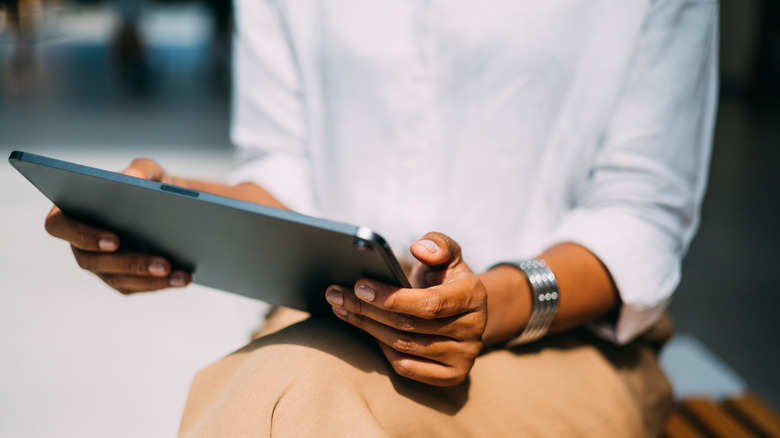 person using iPad outdoors