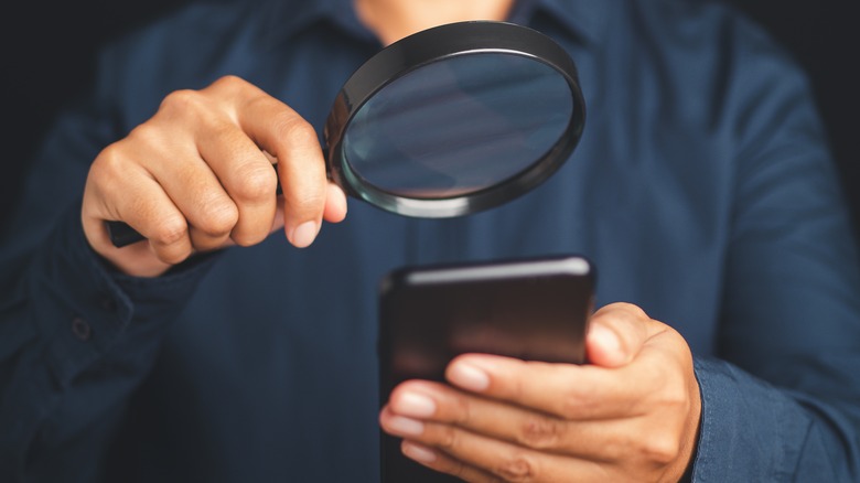 Looking at smartphone magnifying glass