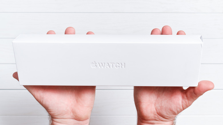 Person holding an Apple Watch box