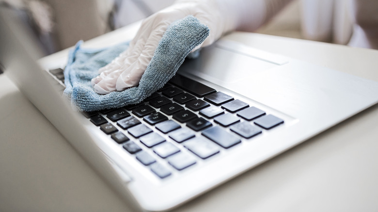 Person cleaning laptop