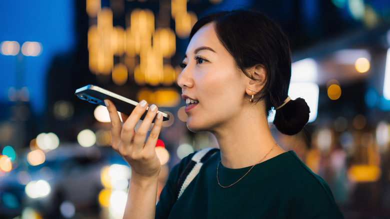 Woman walking outside while speaking into her iPhone