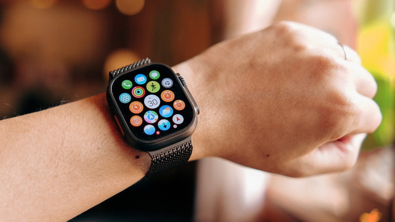 An Apple Watch Ultra 2 is featured on a faceless person's wrist