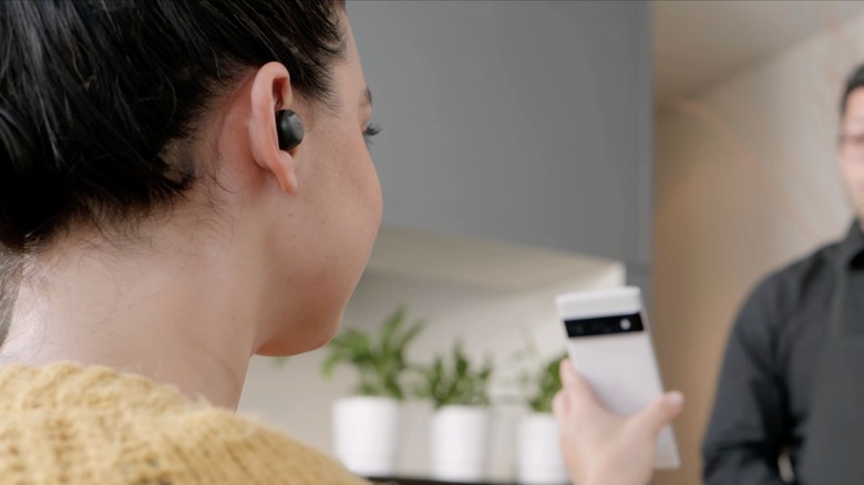 Woman using Google Pixel Buds translate