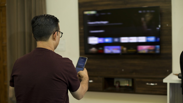 Man casting from phone to TV