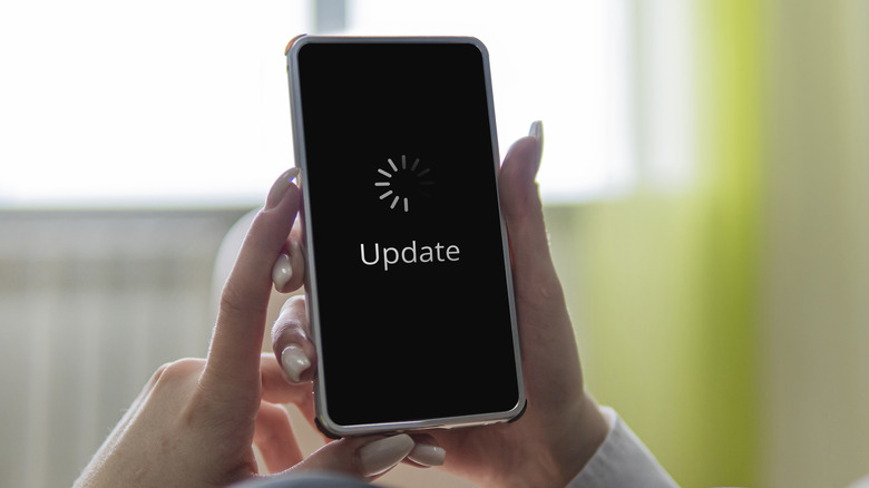 Person holding phone with an update icon