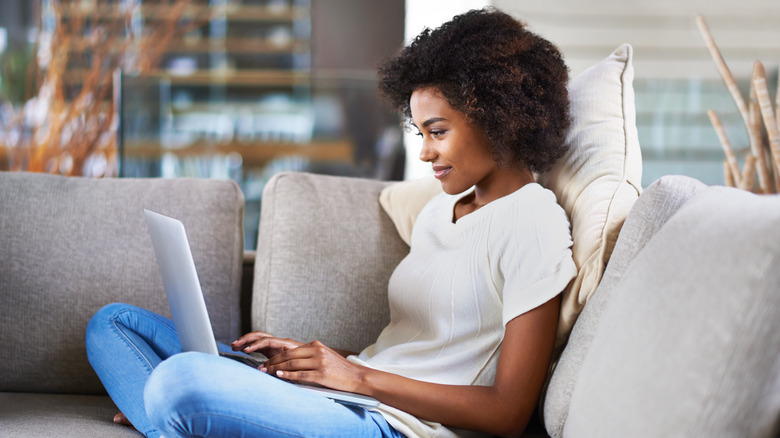 person on couch with laptop