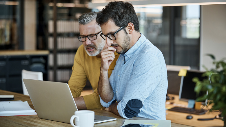 two people looking at laptop