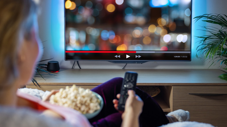 Woman watching Netflix with popcorn