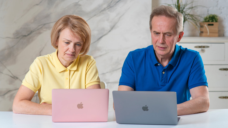 elderly people using MacBook 