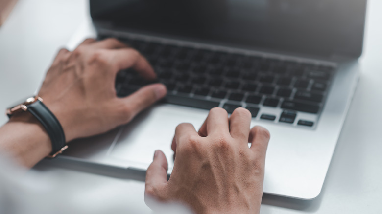 Hands on laptop keyboard