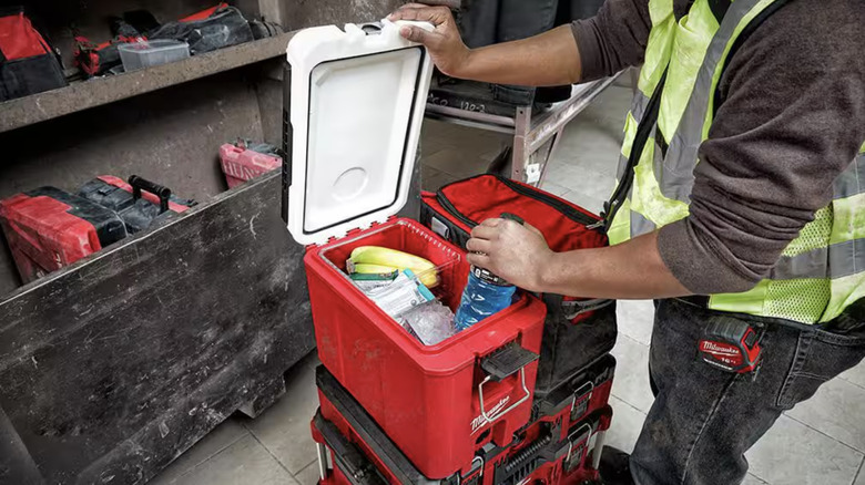 Person pulling out their lunch from a Milwaukee Packout cooler