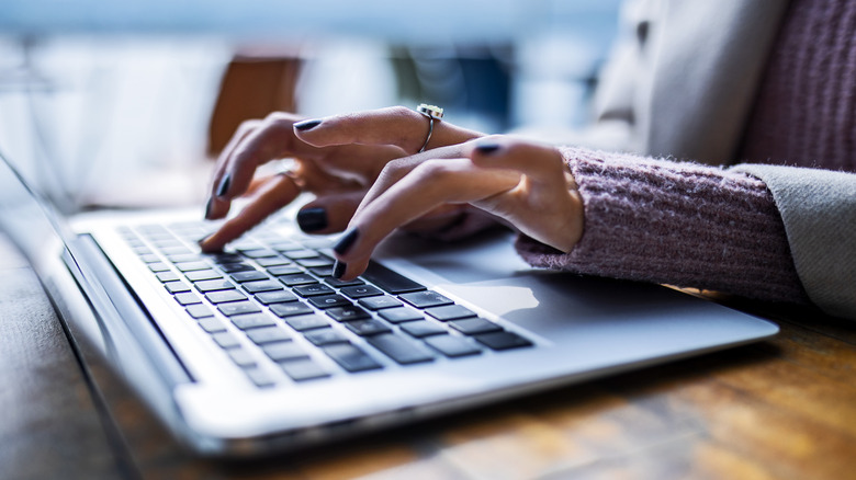 woman typing on laptop