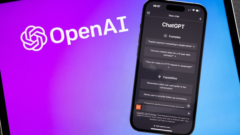 OpenAI logo on screen next to ChatGPT on phone