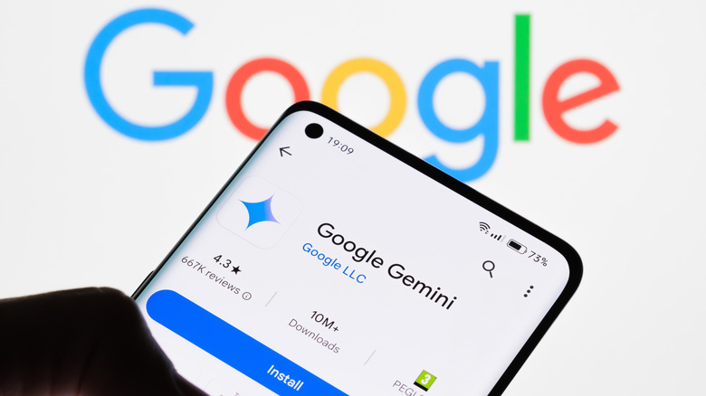 A person installs Google Gemini on his smarphone in front of a Google logo