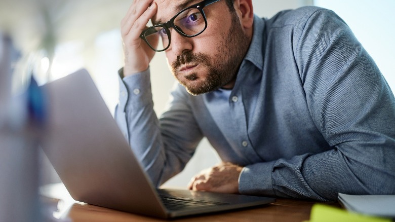 Man frustrated at laptop